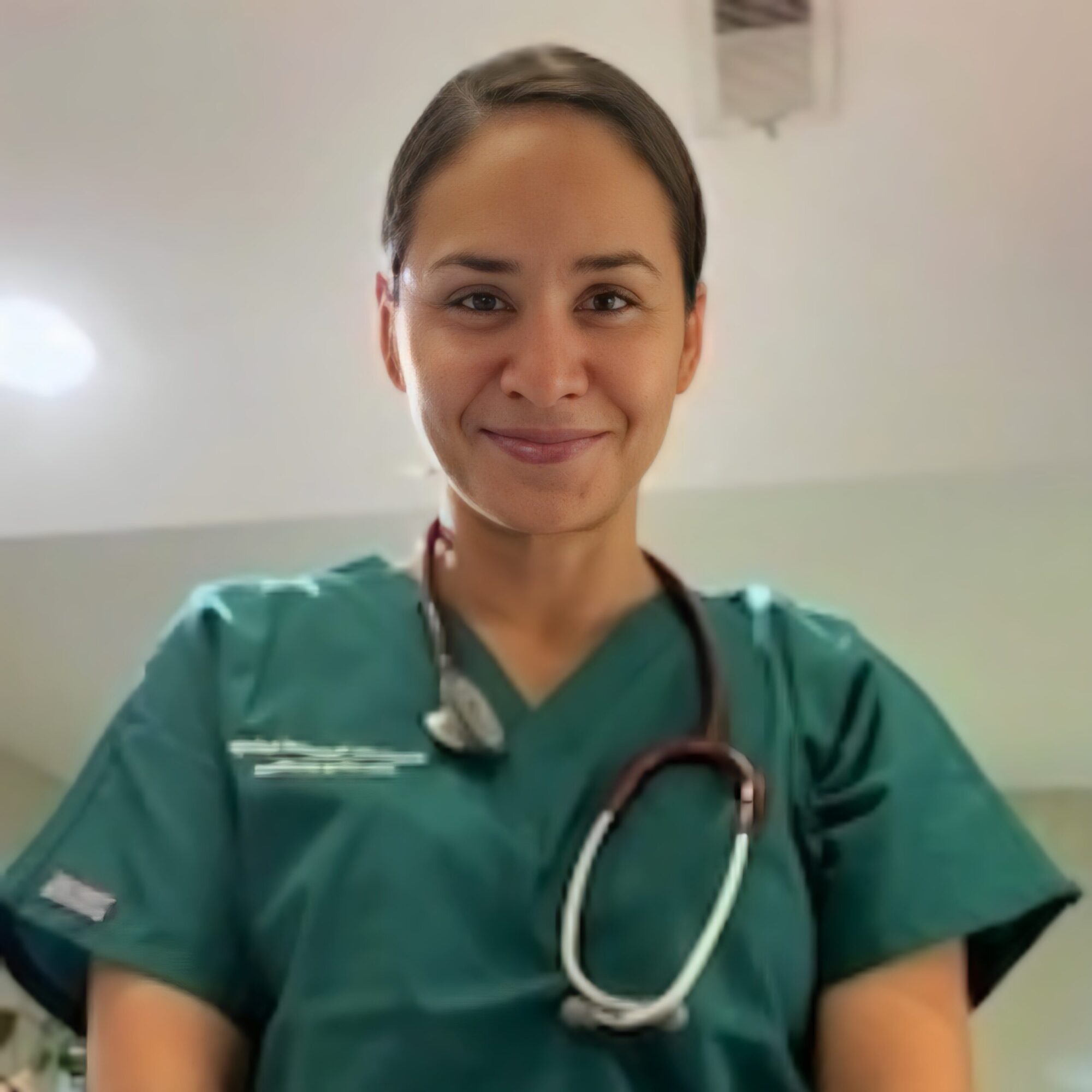Greenville Technical College student in green scrubs with a stethoscope, smiling at the camera.