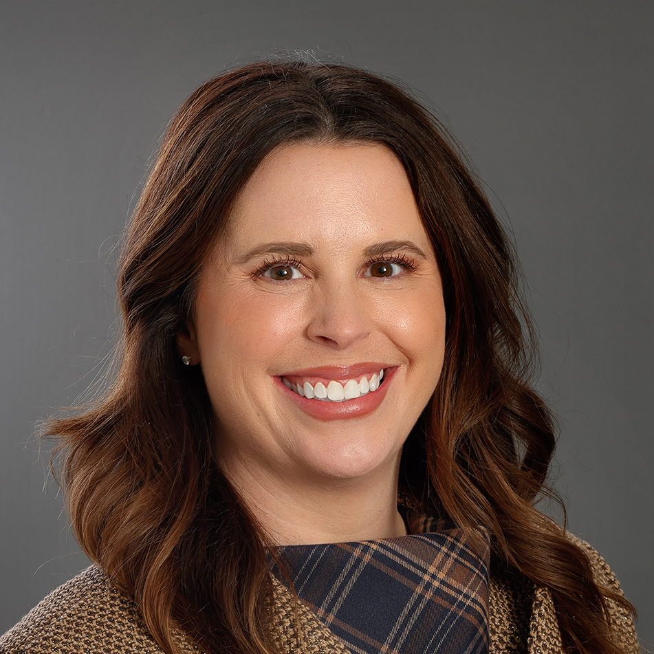 Professional headshot of Greenville Tech Foundation board member Jenna Hendricks McLeod, smiling against a gray background.