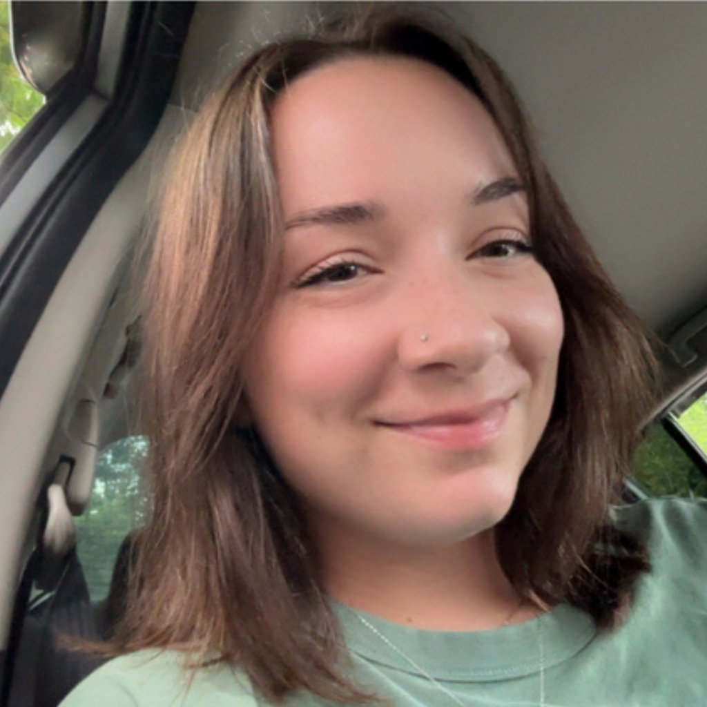 Fallon, a Greenville Technical College Radiologic Technology student, smiles for a selfie while sitting in a car.